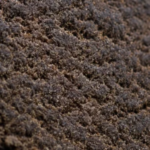 Macro do Afghan Hash 60% THCX, grão seco e reflexos âmbar